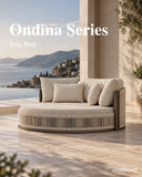 JANSSONG Ondina round outdoor daybed with cream cushions and curved rope detailing on a sea-view terrace
